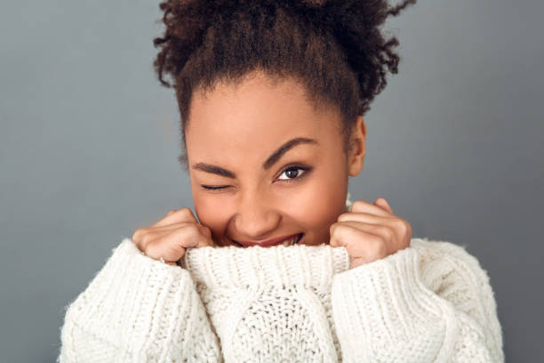 istock Young african woman isolated on grey wall studio winter concept wink 1131863134