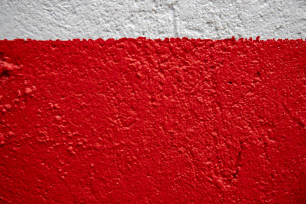 istock White and red painted wall photo. Painted brushed texture. Grungy concrete wall closeup. Rustic architecture background. 1131863528