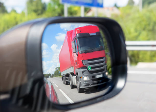 istock truck reflection in a car mirror 1131864886
