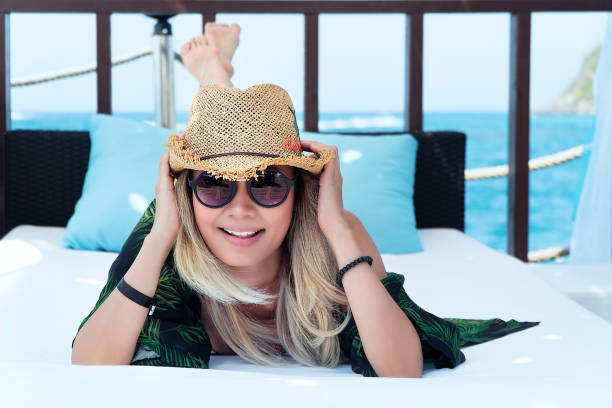 istock Woman having holiday, lying down by the sea 1131866149