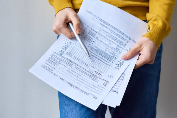 istock Examining individual income tax return document 1131868252