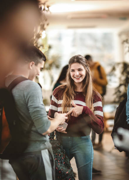 istock Happy high school students talking on a break in a hallway. 1131868408