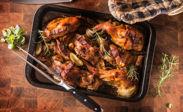 istock Top of view roasted rabbit with onion garlic bacon and herbs. 1131868578