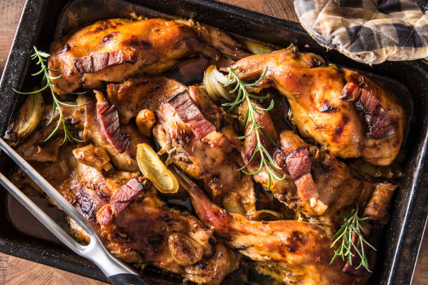istock Top of view roasted rabbit with onion garlic bacon and herbs. 1131868595