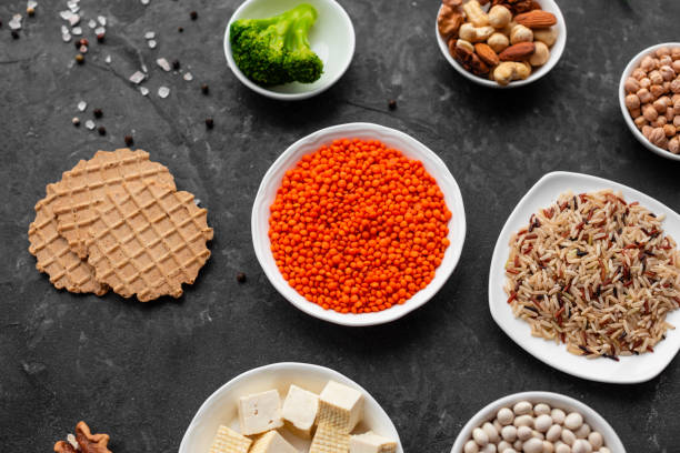istock Superfoods on a gray background with copy space. Nuts, beans, greens and seeds 1131868730