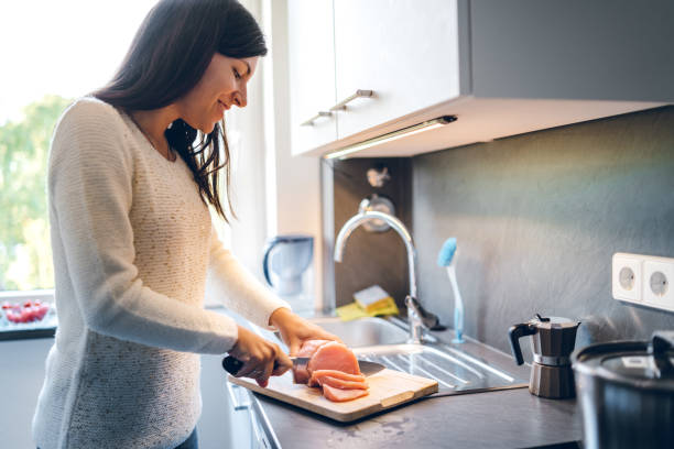 Woman cutting meat