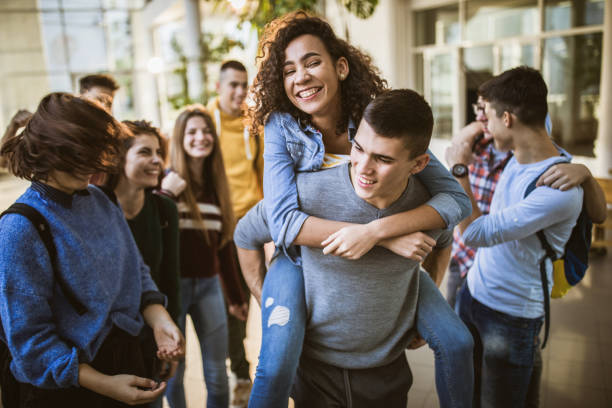 istock Large group of happy students having fun on a break in a hallway. 1131871331