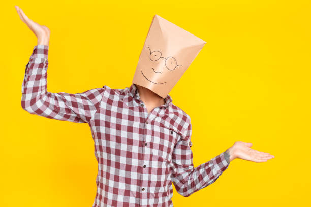 istock Unknown person with a package on his head, drawn funny face 1131871377