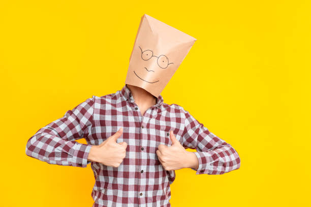 istock Man with a package on his head, showing like sign, cool 1131871388