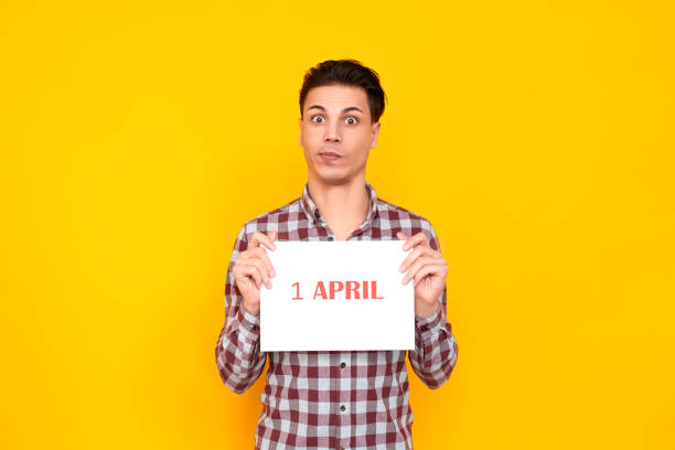 istock Shocked man holding white table with an inscription 1 april 1131871409