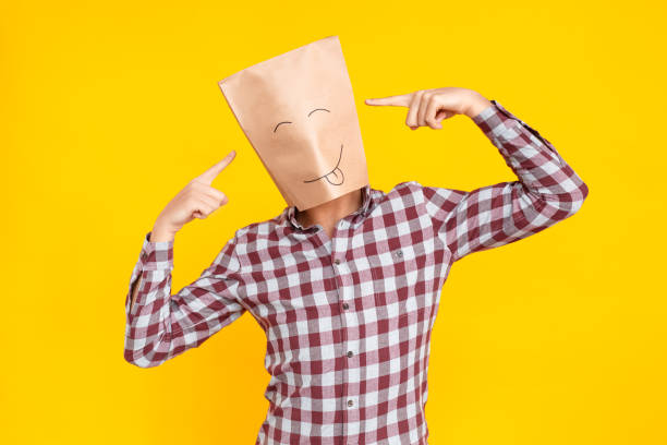 istock Man with package on head,pointing finger at head 1131871414