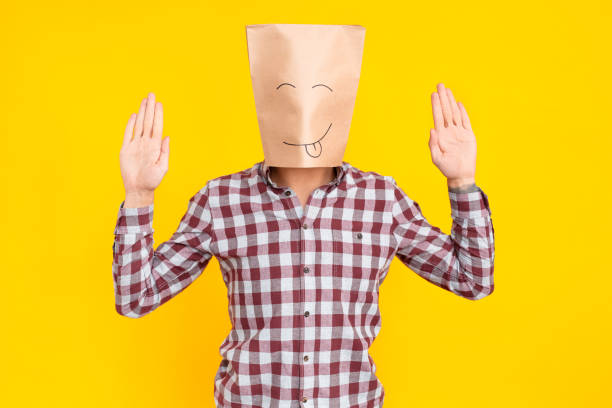 istock Man with package on head, hands up, drawn funny face 1131871415