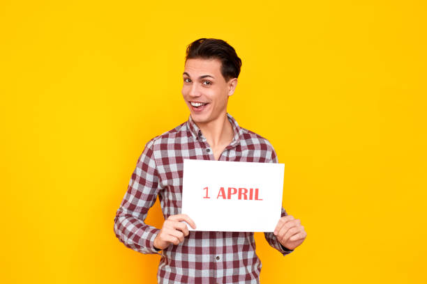 istock Humorist man holding white table with an inscription 1 april 1131871418