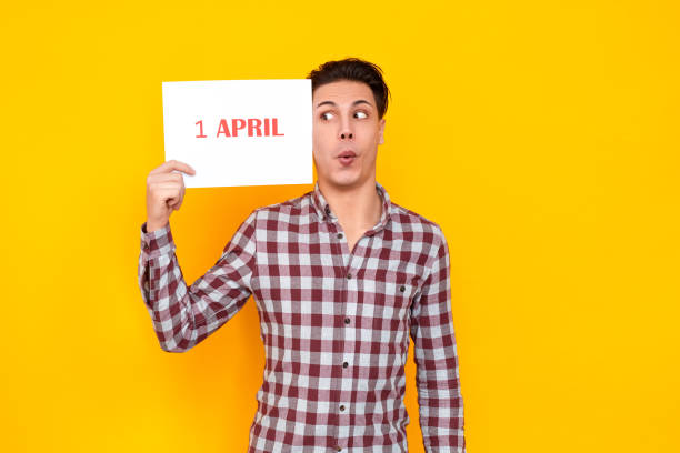 istock Man with surprised face holding table with an inscription 1 april 1131871420