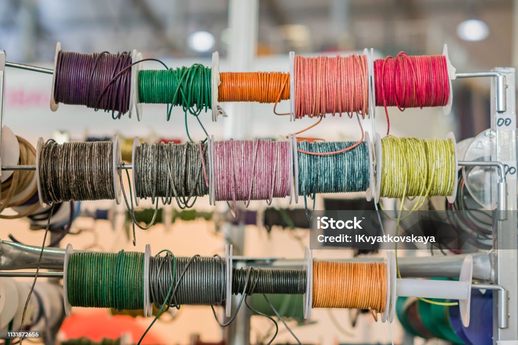Set of spools with leather rope of different colors for sewing or crafting on  market Abstract Stock Photo