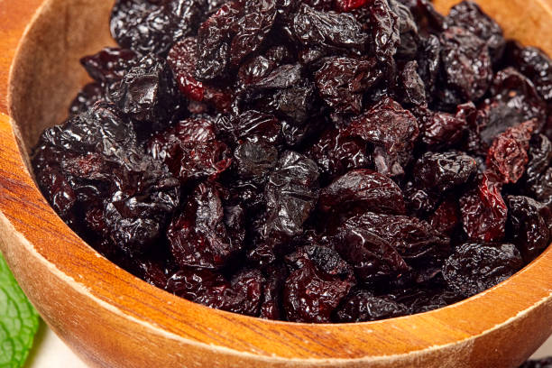 istock Dried grapes, raisins on wooden background. 1131873254