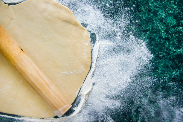 istock Dough on a floured marble green table, top view 1131873902