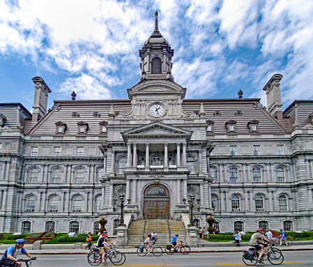 Montreal, Canada - June 2, 2013:  Cyclists in the annual Tour of the Island ride past Montreal City Hall.