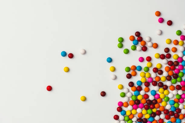 istock Colourful sugar coated chocolate beans on white background 1131874480