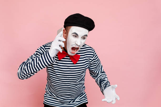 angry man in striped sweater, gloves call in smartphone, shouting - clown circus telephone humor imagens e fotografias de stock