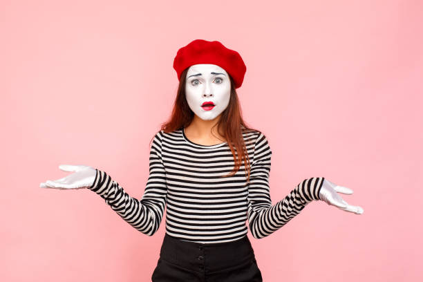 Woman don't now what hapend, have puzzled unhappy look Woman don't now what hapend, have puzzled unhappy look. Clown, artist , mime. Studio shot, pink background mime artist stock pictures, royalty-free photos & images