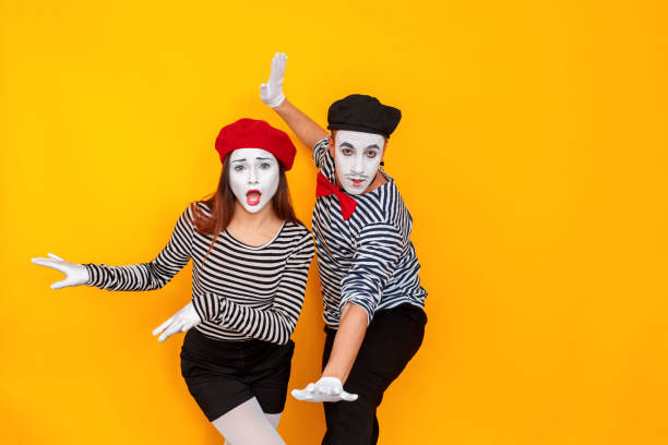 Happiness couple dancing and have good time Happiness couple dancing and have good time. Show time. Indoor shot, yellow background mime artist stock pictures, royalty-free photos & images