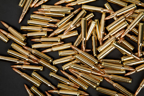 istock Rifle cartridges on a black back 1131878798