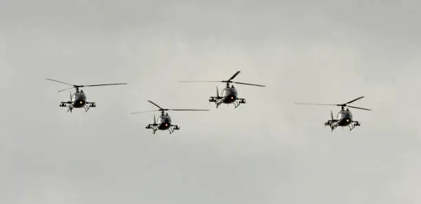 Four helicopters fly in formation