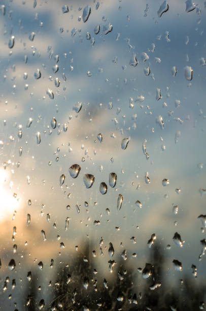 istock raindrops on window glass on background of cloudy sky 1131879949