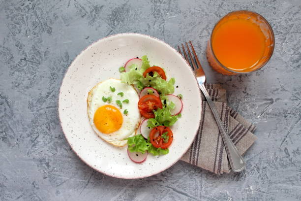 istock Brunch or breakfast concept on dark background. Healthy breakfast fried eggs, salad, pancakes, juice, coffee, granola and dried fruits. 1131880310