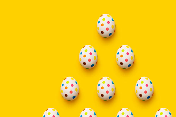 istock Spotty painted colourful easter eggs flat lay  on yellow background 1131881807