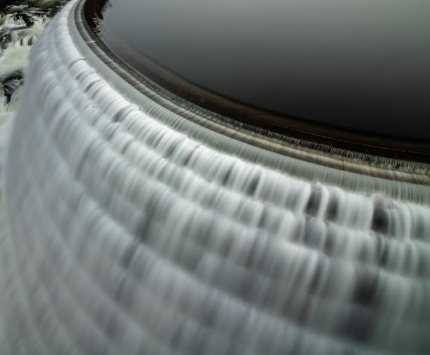 istock Smooth flow of water cascading down a dam from a reservoir. 1131881999