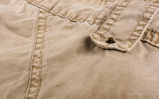 istock clothing items washed cotton fabric texture with seams, clasps, buttons and rivets 1131882156