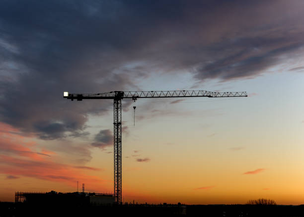 istock Silhouette - Sunset skyline and construction crane 1131882311