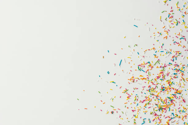 istock Colourful cake sprinkles on white background 1131882315