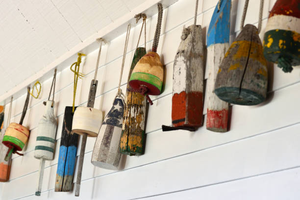 istock Old Decorative Buoys Hanging on a White Wooden Wall 1131883225