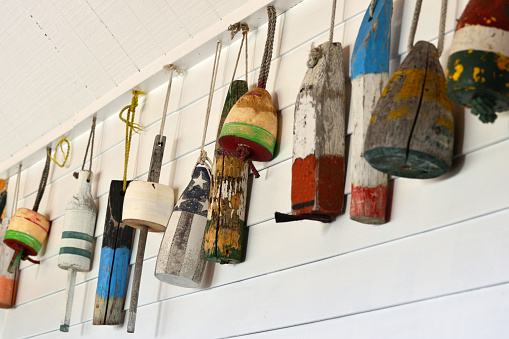 Old Decorative Buoys Hanging on a White Wooden Wall