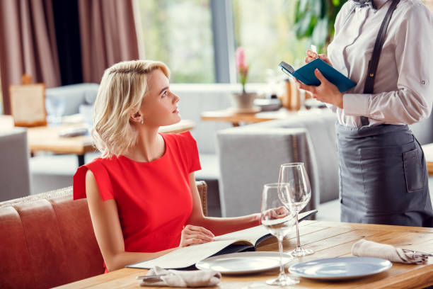 istock Young woman dining in restaurant sitting 1131884297