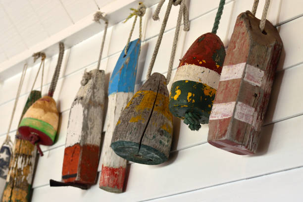 istock Old Decorative Buoys Hanging on a White Wooden Wall 1131884681