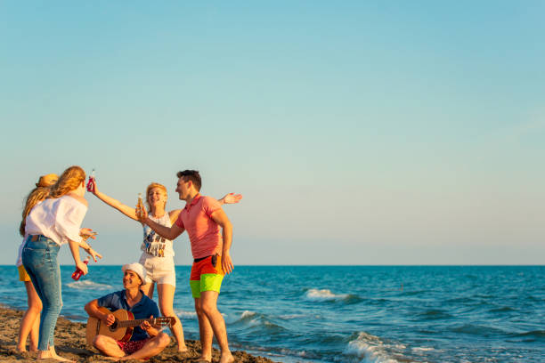 istock Group of friends on the beach enjoy 1131884829