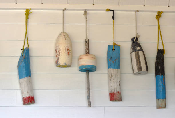 istock Old Decorative Buoys Hanging on a White Wooden Wall 1131884847