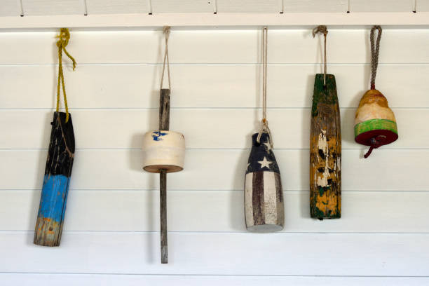 Old Decorative Buoys Hanging on a White Wooden Wall