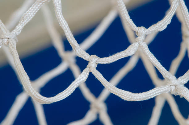istock Empty Swooshing Basketball Net Close Up with blue Background 1131886272