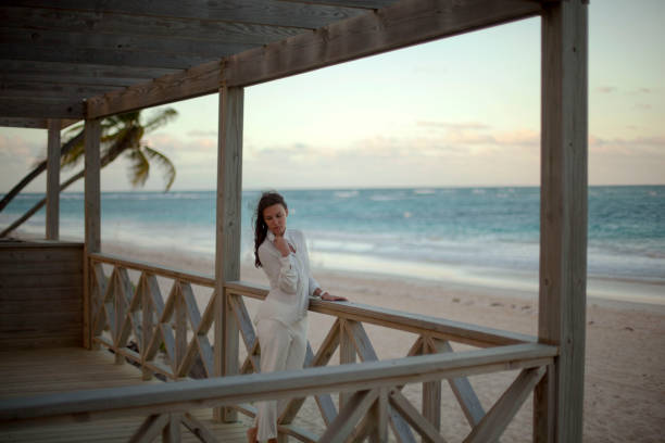 istock Dreamy girl pose on tropical beach 1131887582