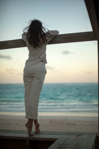 istock Dreamy girl pose on tropical beach 1131887652