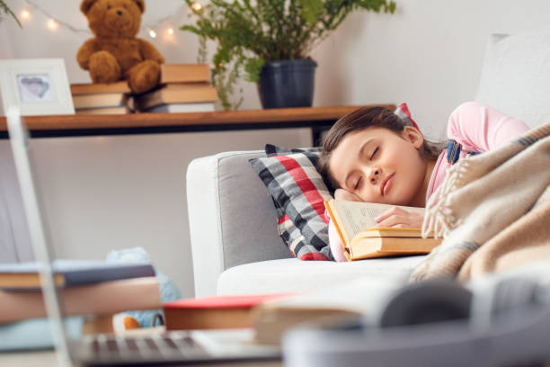 istock Little girl at home lying sleeping peaceful 1131887662