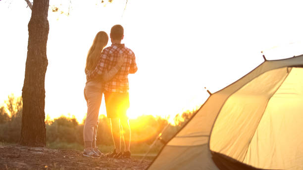 istock Campers looking at sunset and embracing, enjoying beautiful view, good memory 1131888591
