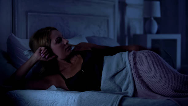 istock Pretty lady lying in bed, thinking about past day, suffering insomnia, sleepless 1131888724