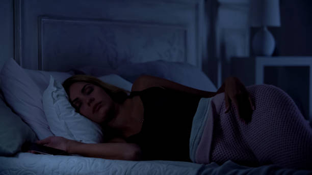 istock Beautiful woman sleeping with smartphone in hands, gadget addiction, application 1131888816