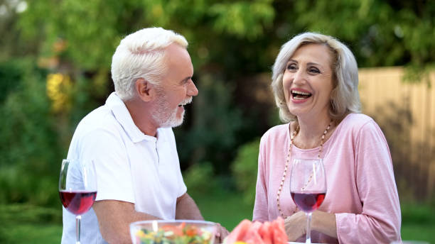 istock Senior couple laughing at dining table, telling funny jokes, remembering moments 1131888867
